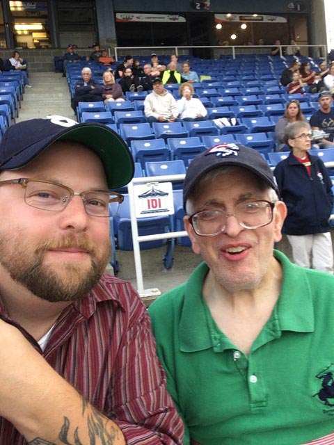 Two happy friends at a baseball game